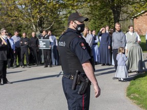 Police ejected about 200 people form the Church of God in Aylmer on Friday May 14, 2021 after a judge ordered the locks on the doors be changed to prevent church gatherings. The keys to the new locks are being held by the court in St. Thomas. (Derek Ruttan/The London Free Press)