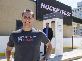 Brad Jones, president of Jones Entertainment, foreground, announced Monday it will be using the Safe Entry System at its upcoming HockeyFest road hockey event. The walk-through scanner detects symptoms of COVID-19. Rahul Kushwah, background, is chief operating office, of Predictmedix, which developed the device. (Derek Ruttan/The London Free Press)