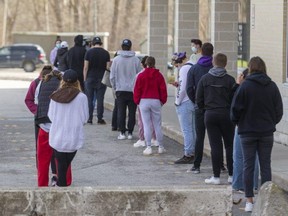 People line up outside the on-campus COVID-19 assessment centre at Western University. Mike Hensen/The London Free Press Line up outside the COVID-19 assessment centre on campus in the Western Student Recreational Centre. (Mike Hensen/The London Free Press)