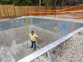 Guy Durston of Warehouse Guys stands inside a new pool going in at a home in the Orchard Park neighbourhood in London. Warehouse Guys and other pool installers say they can't keep up with demand from homeowners who want to put in pools because they're stuck at home during the COVID-19 pandemic. Photograph taken on Friday May 7, 2021. (Mike Hensen/The London Free Press)