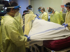 A COVID-19 patient is treated at the intensive care unit at the Peter Lougheed Centre in Calgary on November 14, 2020. Leah Hennel/Alberta Health Services