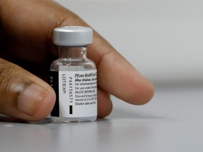 FILE PHOTO: A medical worker prepares to dilute a vial of Pfizer-BioNTech vaccine at a coronavirus disease (COVID-19) vaccination centre. Ten people who received the Pfizer vaccine at the Lethbridge Exhibition at the end of April are being contacted by Alberta Health Services after it was determined five of them were unknowingly given saline instead of a dose of COVID-19 vaccine.