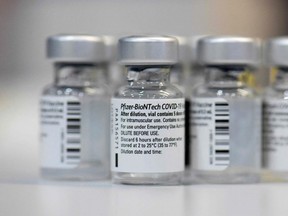 In this file photograph taken on January 22, 2021, empty vials of the Pfizer-BioNTech Covid-19 disease vaccine are displayed at the regional corona vaccination centre in Ludwigsburg, southern Germany. Alberta Premier Jason Kenney was the first to announce that starting on Monday, the province would make Pfizer-BioNTech vaccines available to everyone aged 12 and up, the day after high COVID-19 transmission rates forced the closure of schools in his province.