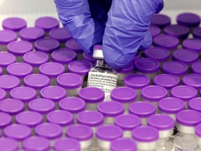 A health-care worker prepares a dose of the Pfizer-BioNtech Covid-19 vaccine.