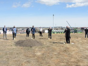 Airdrie City Council stands with MLAs Angela Pitt and Ric McIver as well as representative from EllisDon Construction Services as they break ground on the 40 ave. and QEII Interchange. Photo by Riley Cassidy