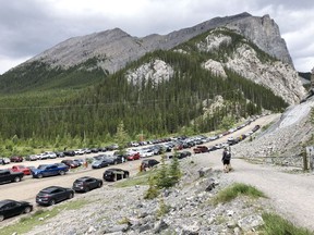 There was a large influx of visitor traffic to the Bow Valley recorded last year. (Pictured) Vehicles line the road as the car park at Ha Ling trail head filled to capacity and hundreds take to the mountains all at once on July 11, 2020. Photo Marie Conboy.