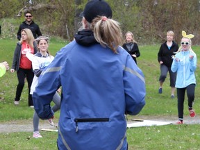 Fitness Powers leads walkers in a warmup  routine before beginning the Investors Group Walk For Alzheimer's at Sandbanks Provincial Park Saturday, May 12, 2018 in Prince Edward County. The Alzheimer Society of Hastings-Prince Edward's current walk is a month-long virtual event.