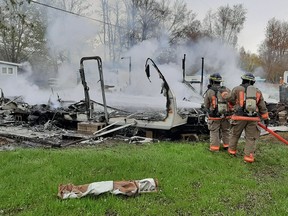 Belleville volunteer firefighters extinguish a fire at a trailer park on Carleton Cove Road Friday morning.