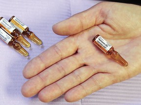 A public health nurse holds a vial of naloxone, a temporary antidote for narcotic overdose, in 2017 at Hastings Prince Edward Public Health. A new report by several Ontario agencies shows a large increase in opioid-related deaths in 2020 and calls for greater access to naloxone and more.