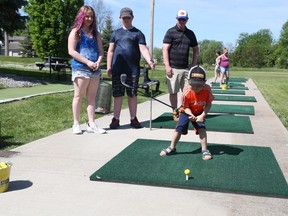 The Zadworny family took advantage of a beautiful morning Monday to hit some golf balls on the range at Nine Golf (formerly Bayview Golf Centre) in Quinte West.  Pictured watching Miller tee off are (from left) Hannah, Tanner and their father Dan. BRUCE BELL