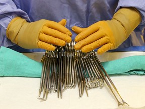 A nurse prepares surgical instruments for use at Belleville General Hospital in 2014. Quinte Health Care is reopening some surgery services in Belleville and Trenton.