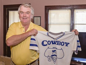 John Coulson, who managed and later owned The Cowboy bar on Colborne Street in downtown Brantford, Ontario holds a jersey with the bar's logo on it. The landmark nightclub was demolished in April.