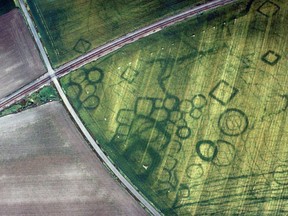 Cropmarks, along with parch marks, soil marks and frost marks, can reveal buried archeological sites that are not visible from the ground. These cropmarks are at a site at Grézac, France.