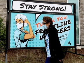 Sherry Tanney, a personal support worker at Brockville General Hospital, walks past a sign on the hospital grounds offering encouragement to front-line workers amid the COVID-19 pandemic on Monday afternoon. (RONALD ZAJAC/The Recorder and Times)
