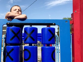 Oliver Benoit, 4, of Brockville, pauses at a play structure at Rotary Park on Thursday afternoon. The city has kept playgrounds accessible, and on Saturday this tolerance of cautious outdoor play will become official. (RONALD ZAJAC/The Recorder and Times)