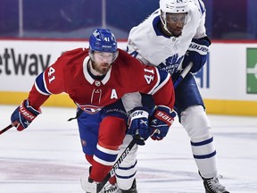 Paul Byron (left) of the Montreal Canadiens skates against Wayne Simmonds of the Toronto Maple Leafs during overtime in game six of their best-of-seven NHL playoff series on Saturday night. Montreal won 3-2 to tie the series and force a seventh and deciding game Monday night.
Minas Panagiotakis/Getty Images