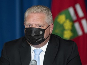 Ontario Premier Doug Ford listens to a question during a press conference at the Ontario Legislature in Toronto, Thursday, May 13, 2021.
