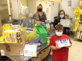 Raelyn Drew,11, middle, and her brother Johnathan, 7, dropped another large donation of food to the Salvation Army Family Services location in Chatham on April 30. Allie Matthews, manager of Salvation Army Family Services, back left, says this is one of several donations the Drew family has made.  Ellwood Shreve/Postmedia Network