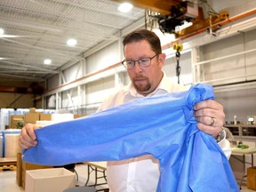 Windsor-based Harbour Technologies is expanding is personal protective equipment manufacturing operations to Chatham-Kent. Co-owner David Glover is seen here with one of the PPE gowns the company manufacturers. He says the Chatham plant ill be hiring as many as 80 new employees. Handout