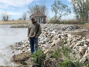 Darrell Shadd stands in front of a flood protection system he built on the waterfront of his Shrewsbury, Ont. home that both 'trips' incoming waves from Rondeau Bay to help decrease the splash and allows water to drain back into the bay. Ellwood Shreve/Postmedia Network