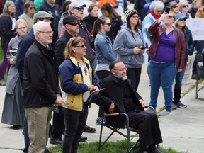 Pastor Henry Hildebrandt, seated, of Aylmer's Church of God is among the protesters at an anti-lockdown rally at Tecumseh Park in Chatham on April 26. Mark Malone/Postmedia Network