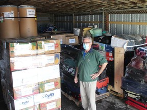 Miguel Hernandez, a volunteer with the Chatham-Kent chapter of Canadian Food for Children, displays part of the next shipment that will be sent to help families in developing nations. Ellwood Shreve/Chatham Daily News/Postmedia Network