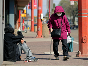 A woman walks on 97 Street in Edmonton's downtown Chinatown district on Monday May 10, 2021.