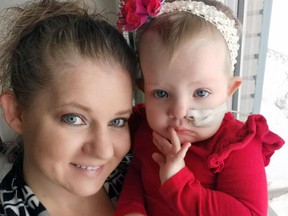 Mitchell's Mandy Nicholson holds her two-year-old daughter Claire. The two-year-old has fought leukemia for the better part of a year and it recently relapsed, but the community is rallying to the family's aid during the extended battle.