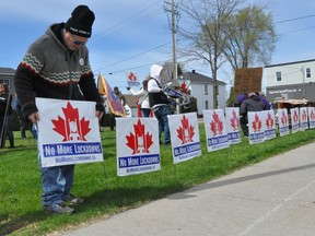 Protesters set up a line of anti-lockdown signs along Pitt Street on Saturday May 1, 2021 in Cornwall, Ont. Francis Racine/Cornwall Standard-Freeholder/Postmedia Network