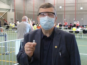 Dr. Paul Roumeliotis with a vial of vaccine at Tuesday's clinic held at the Benson Centre. Photo on Tuesday, May 18, 2021, in Cornwall, Ont. Todd Hambleton/Cornwall Standard-Freeholder/Postmedia Network