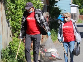 Susan and Doug Crites out on a small laneway in east-end Cornwall, and two of dozens of volunteers involved in the cleanup effort.Photo on Saturday, May 29, 2021, in Cornwall, Ont. Todd Hambleton/Cornwall Standard-Freeholder/Postmedia Network