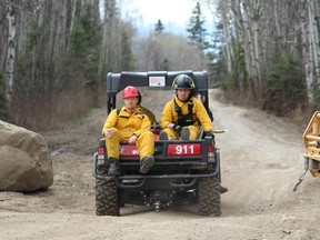 A pair of Alberta Forestry staff are brought into the Abasand trail system to help battle a bush fire on Saturday, April 30, 2016. The fire was declared completely extinguished the next day at noon. Vincent McDermott/Fort McMurray Today/Postmedia Network ORG XMIT: POS1607121926178722