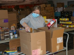 A volunteer packs supplies at the Wood Buffalo Food Bank in Fort McMurray, Alta. on Monday, March 8, 2021. Sarah Williscraft/Fort McMurray Today/Postmedia Network