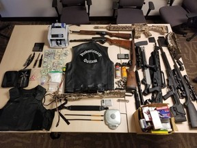 Canadian currency, weapons, drugs and other items seized by the Biker Enforcement Unit during a multi-jurisdictional drug trafficking investigation that culminated in April. The multi-jurisdictional investigation cost the Kingston Police $19,500 in overtime. (Supplied Photo)