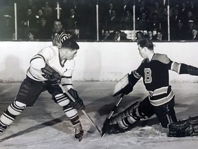 Barrie Flyers netminder Bob Senior stymies Toronto Marlboros' Bob Pulford with a nifty skate save.