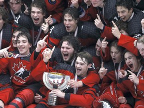 Canada, including captain and Kingston Frontenacs centre Shane Wright, front row, middle,  celebrates with the championship trophy after defeating Russia 5-3 in the 2021 IIHF U18 World Championship gold medal game at Comerica Center on May 6, 2021, in Frisco, Texas.
