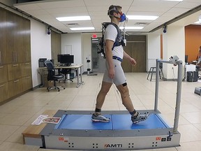 An exoskeleton is demonstrated at the Queen's University faculty of engineering and applied science in an undated photo. The exoskeleton was manufactured so users can walk farther while using less energy.