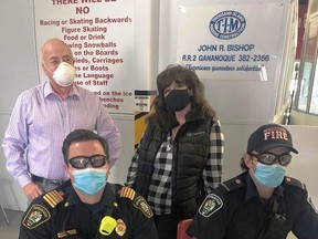 Gananoque Mayor Ted Lojko (standing) and CAO Shelley Fournier, Fire Chief Gord Howard (seated) and firefighter Tim McFadden came out to assist at the COVID-19 vaccine clinic at the Lou Jeffries Arena on May 25  supplied by Dennis O'Connor