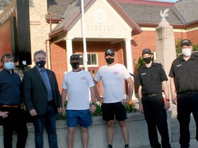 OPP sergeants Patrick Armstrong and Dave Matheson walked 100 km from the Ilderton Arena up to Wingham on May 22-23 in support of the Dave Mounsey Memorial Fund. During their stop in Exeter on the evening of May 22, Armstrong and Matheson were greeted by members of South Huron council and the South Huron Fire Department. From left are Coun. Aaron Neeb, Mayor George Finch, Matheson, Armstrong and firefighters Jason Pollard and Andrew Snedden. About $16,000 was raised during the walk, more than doubling the $7,500 goal. Scott Nixon