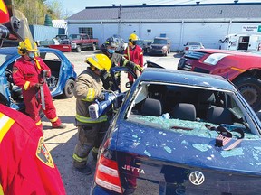 Photo by FIREFIGHTER WILLIAM ELLIOTT
On Saturday, May 15, Elliot Laker firefighters spent the day training to use the Jaws of Life on old derelict cars. They get to train on the extrication tools a couple of times a year. For the story, see page 4.