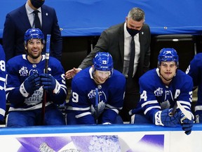Toronto Maple Leafs head coach Sheldon Keefe congratulates Toronto Maple Leafs forward Jason Spezza (19) on his hat trick along with forward John Tavares (91)  and forward Auston Matthews (34) during the third period at Scotiabank Arena on Feb. 4. Toronto defeated Vancouver.
