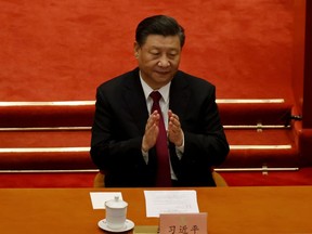Chinese President Xi Jinping applauds at the closing session of the Chinese People's Political Consultative Conference (CPPCC) at the Great Hall of the People in Beijing, China, on March 10, 2021. The session included included a vote in favour of a resolution to overhaul Hong Kong's electoral system.