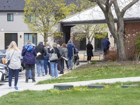 People line up at the COVID-19 vaccination clinic at the Caradoc Community Centre in Mt. Brydges on April 19. Derek Ruttan/Postmedia Network