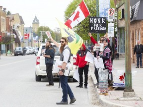 Fifteen people protest COVID-19 lockdown restrictions outside of the post office in Glencoe on Friday, May 7. Derek Ruttan/Postmedia Network