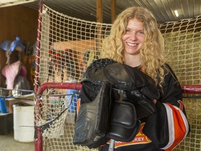 Taya Currie, a goaltender with the AAA U16 Elgin-Middlesex Chiefs, has a chance in June to become the first female player chosen in an Ontario Hockey League draft. She was photographed in her family's barn in Parkhill on May 2. Mike Hensen/Postmedia Network