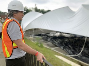 Simon Marsden, the Stratford Festival's director of production, watches as one of the Festival's two tents is raised adjacent to the Tom Patterson Theatre. With COVID-19 protocols limiting indoor events, the Festival will stage six plays and five cabarets outdoors this season. Each tent can seat up to 150 guests, but the exact number will depend on provincial guidelines at the time.