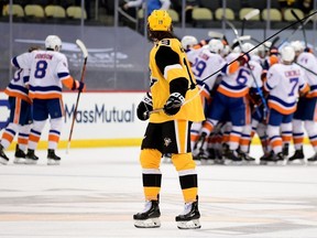Jared McCann of the Pittsburgh Penguins watches as the New York Islanders celebrate their 4-3 win during overtime in Game One of the First Round of the 2021 Stanley Cup Playoffs at PPG PAINTS Arena on May 16, 2021 in Pittsburgh.