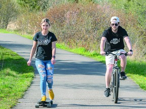 WEEKEND WARRIORS: Friday afternoon's warm weather brought out the skateboards and bicycles on the John Rowswell Hub Trail. After a long day at work Shaw and Brittney decide on sunshine and exercise to kick off the weekend. BOB DAVIES/SAULT THIS WEEK