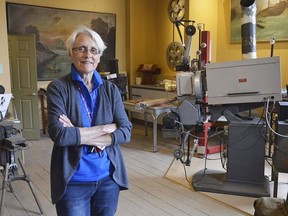 The Kiwanis Club of Forest's Ruth Illman stands on the second floor of the Kineto Theatre in this file photo, among artifacts from the building's 100-plus-year history.