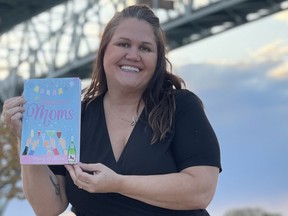 Sarnia's Mary O'Hora poses with her new book by the Blue Water Bridge. (Submitted)